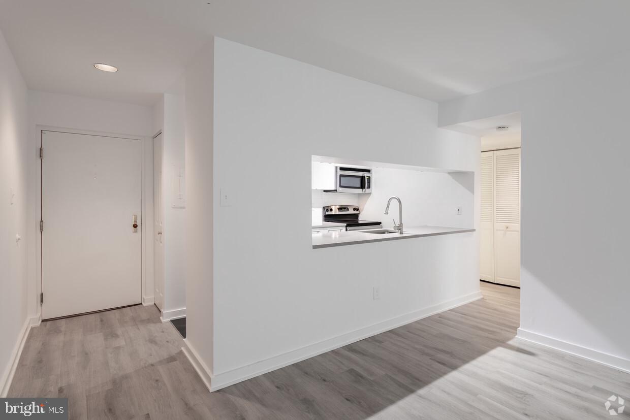 601 24th Street Northwest, Unit 301 Washington, DC 20037 - Photo 3 of 8 a view of kitchen and wooden floor