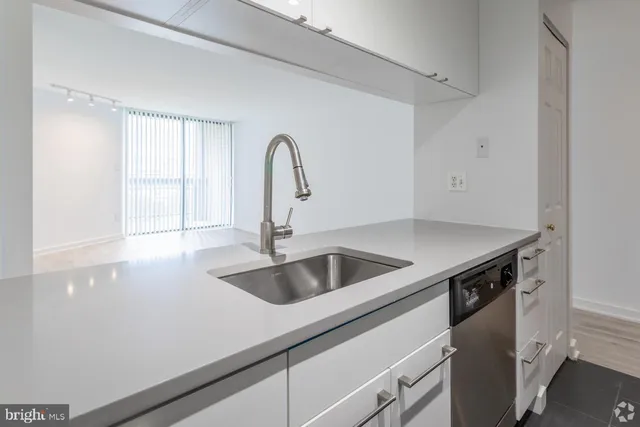 a kitchen with a sink and a refrigerator