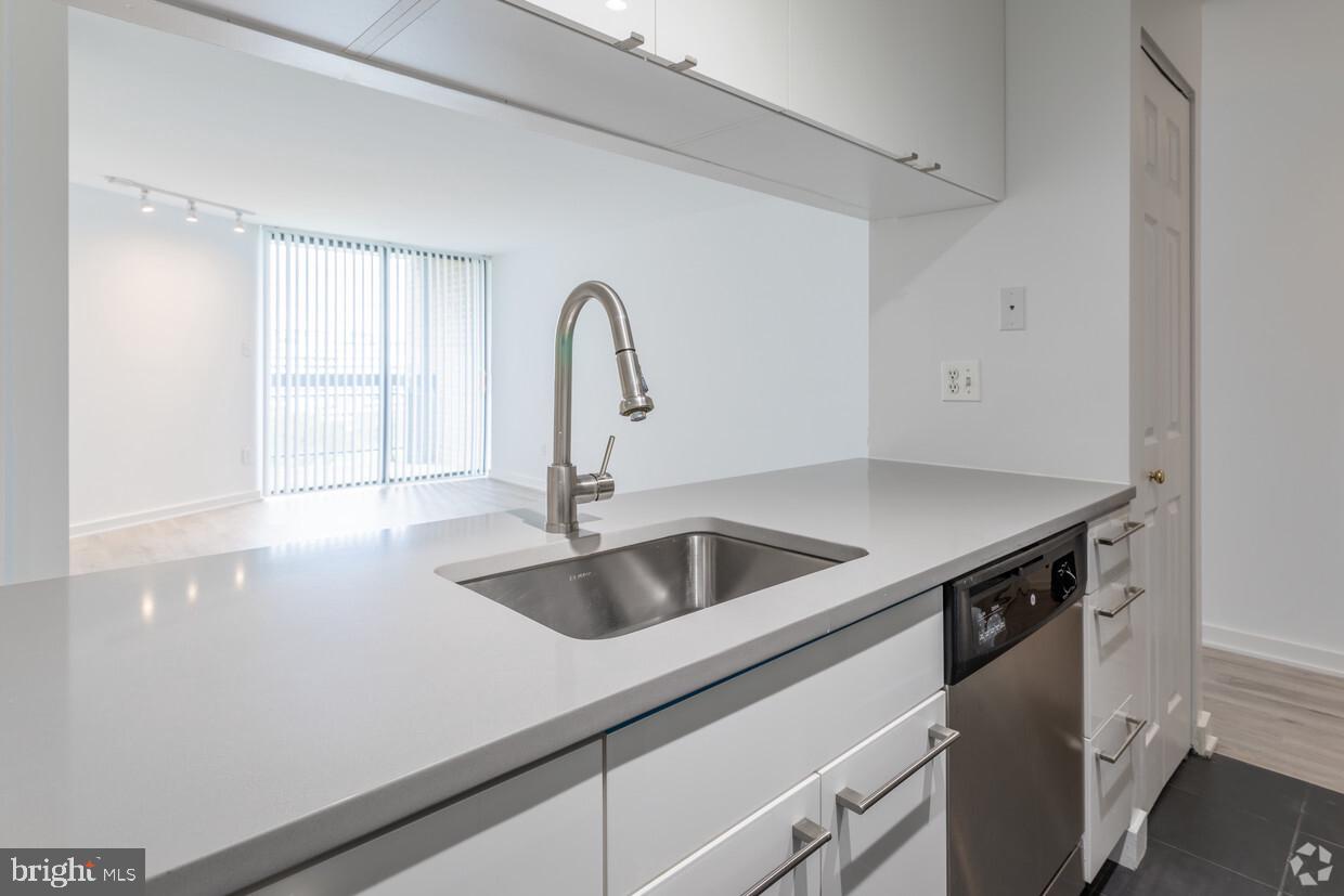 601 24th Street Northwest, Unit 301 Washington, DC 20037 - Photo 5 of 8 a kitchen with a sink and a refrigerator
