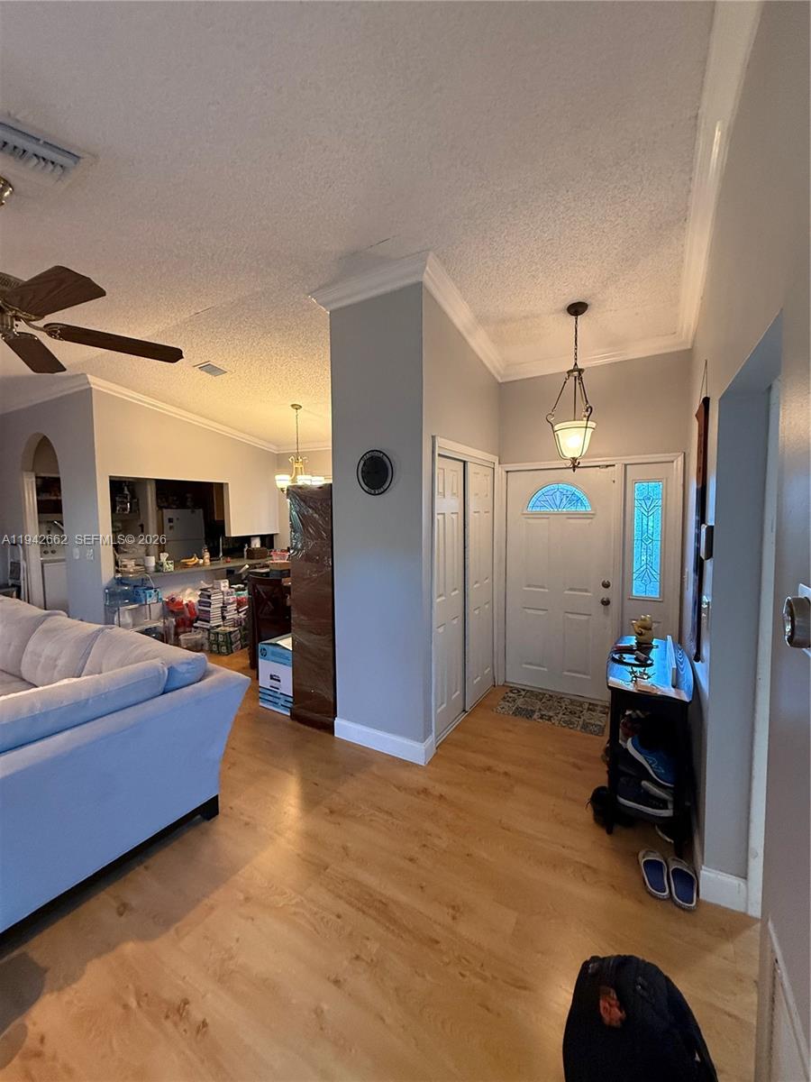 6190 Pine Tree Lane Tamarac, FL 33319 - Photo 3 of 29 a living room with furniture a dining table and kitchen view