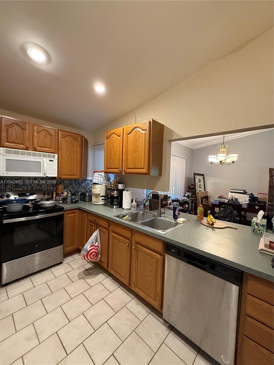 6190 Pine Tree Lane Tamarac, FL 33319 - Photo 8 of 29 a large kitchen with a sink and cabinets