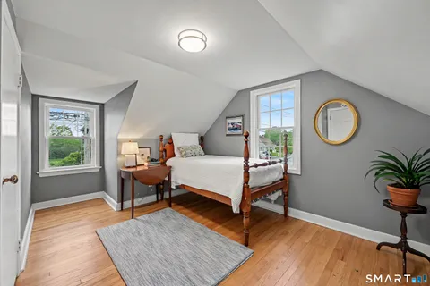 a bed room with furniture and a window