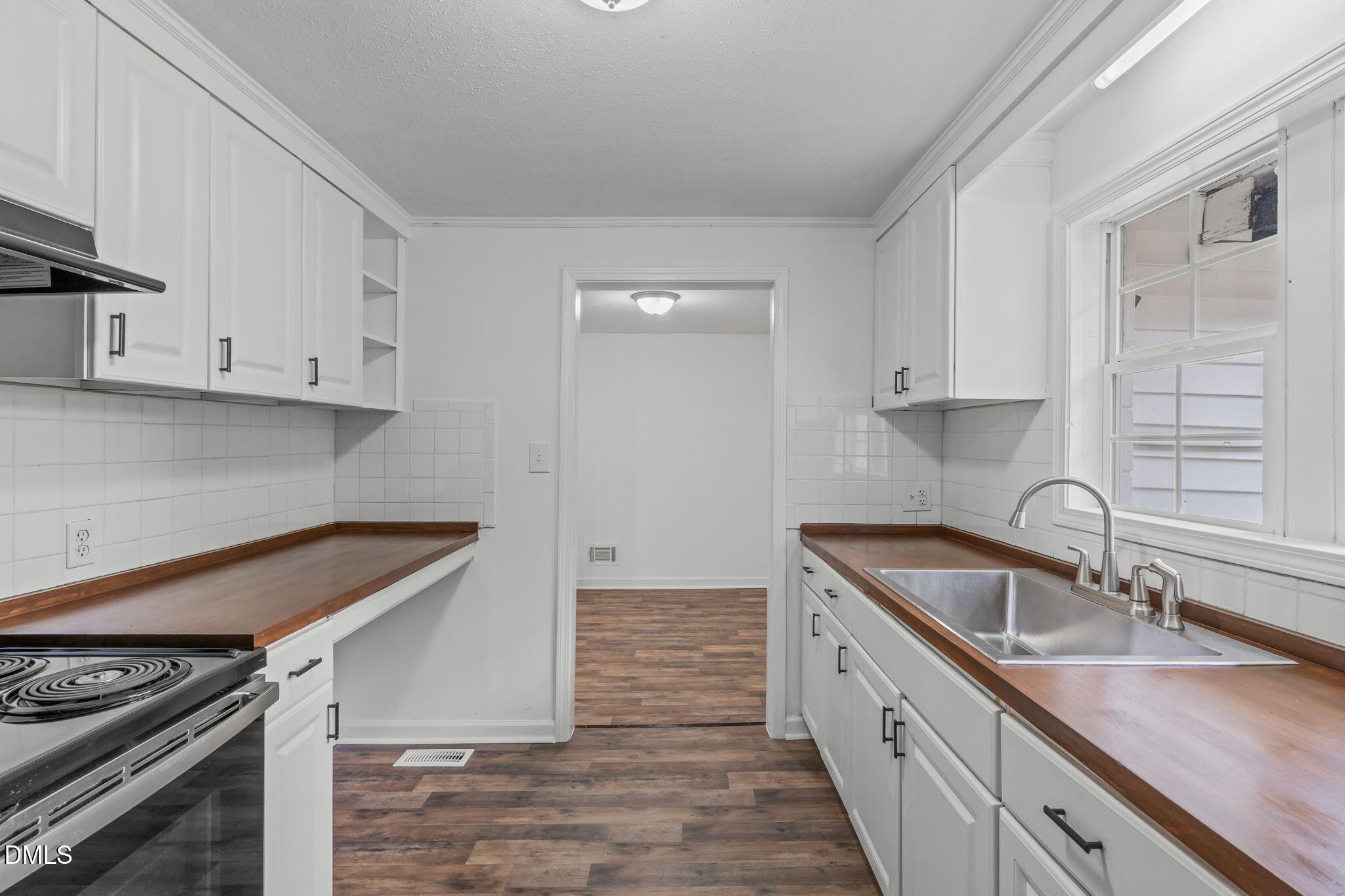 311 New Rand Road Garner, NC 27529 - Photo 11 of 31 a kitchen that has a sink and a stove