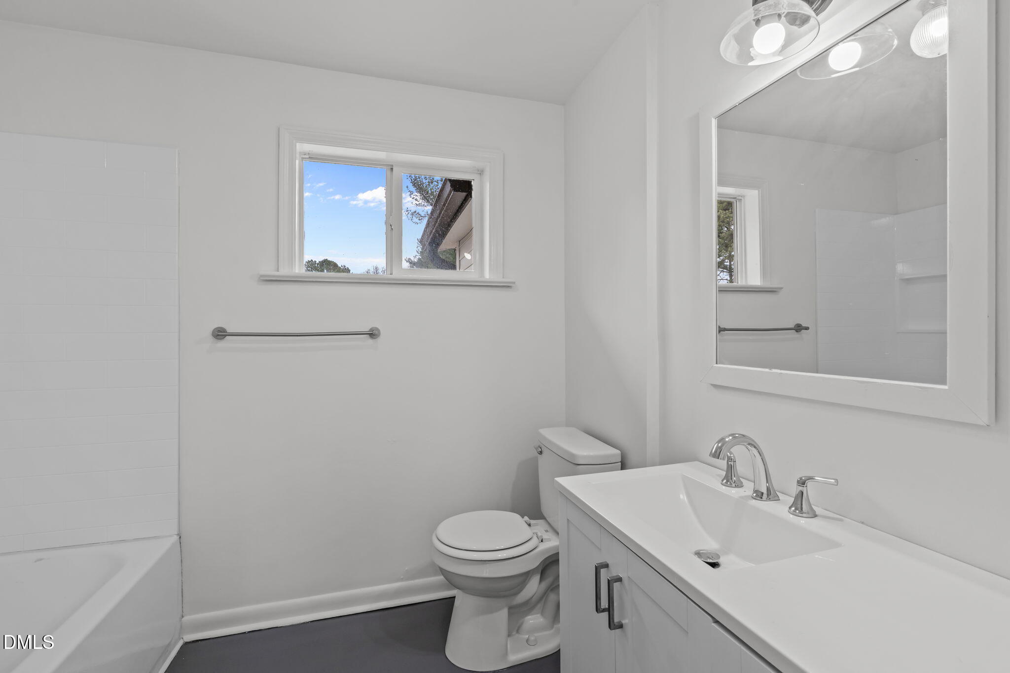 311 New Rand Road Garner, NC 27529 - Photo 16 of 31 a bathroom with a toilet a sink and mirror