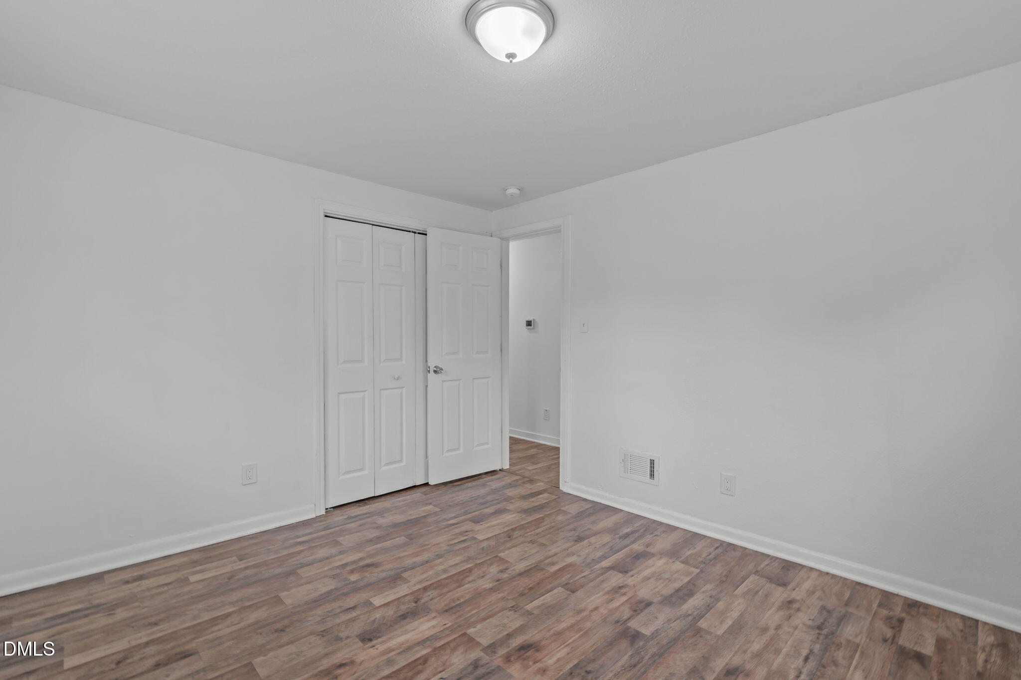 311 New Rand Road Garner, NC 27529 - Photo 20 of 31 a view of an empty room and wooden floor