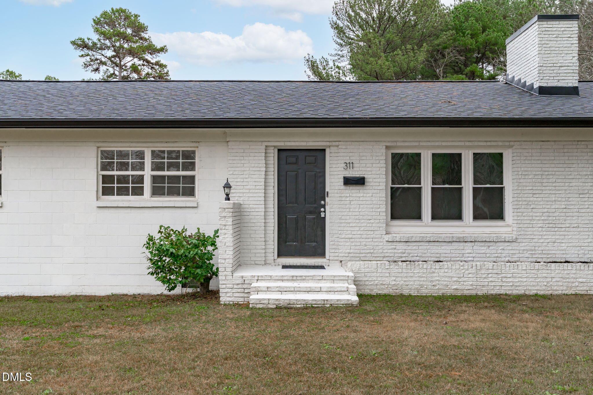 311 New Rand Road Garner, NC 27529 - Photo 2 of 31 a front view of a house with a garden