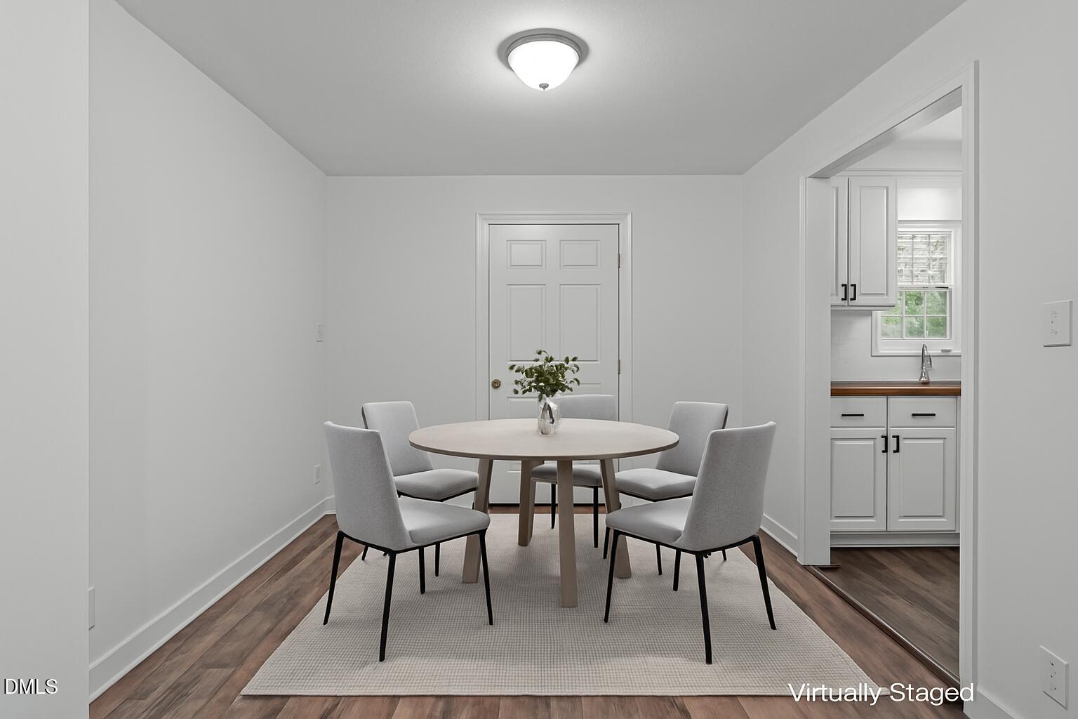 311 New Rand Road Garner, NC 27529 - Photo 4 of 31 a view of a dining room with furniture and wooden floor