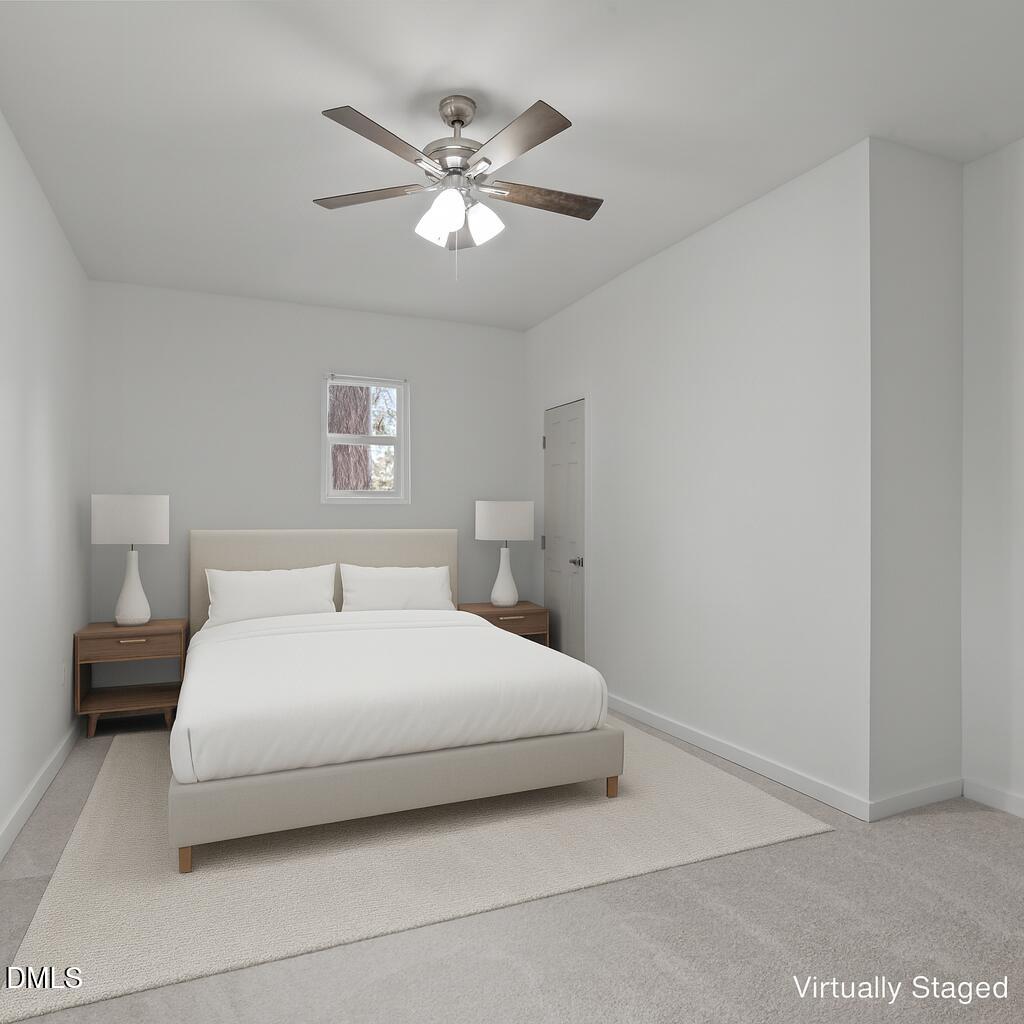 311 New Rand Road Garner, NC 27529 - Photo 5 of 31 a bedroom with a bed and a chandelier