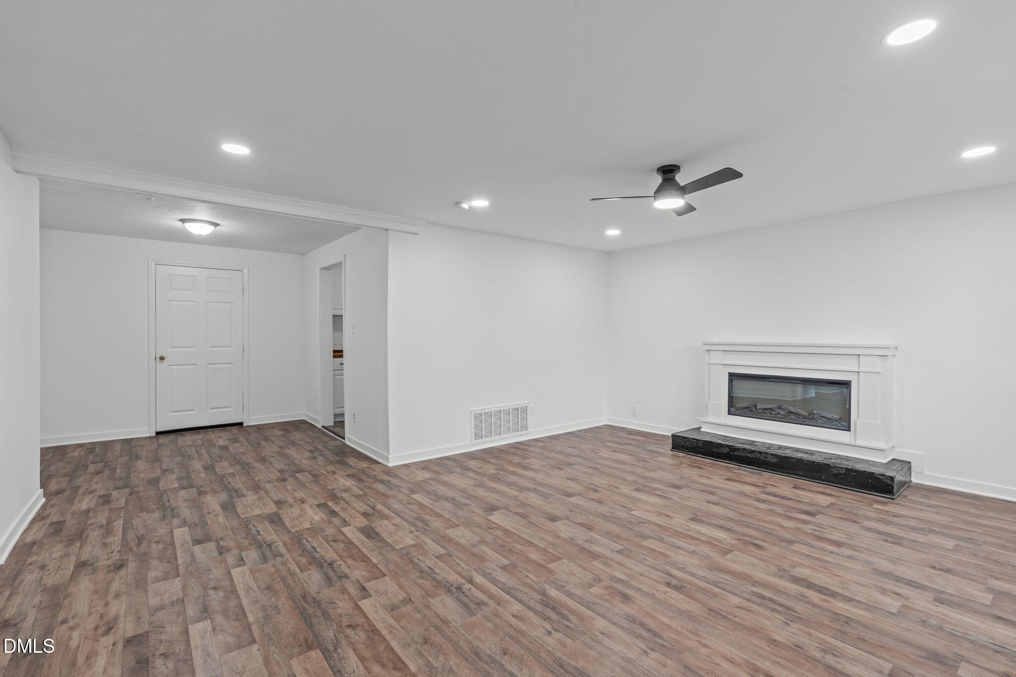 311 New Rand Road Garner, NC 27529 - Photo 8 of 31 a view of an empty room with a fireplace