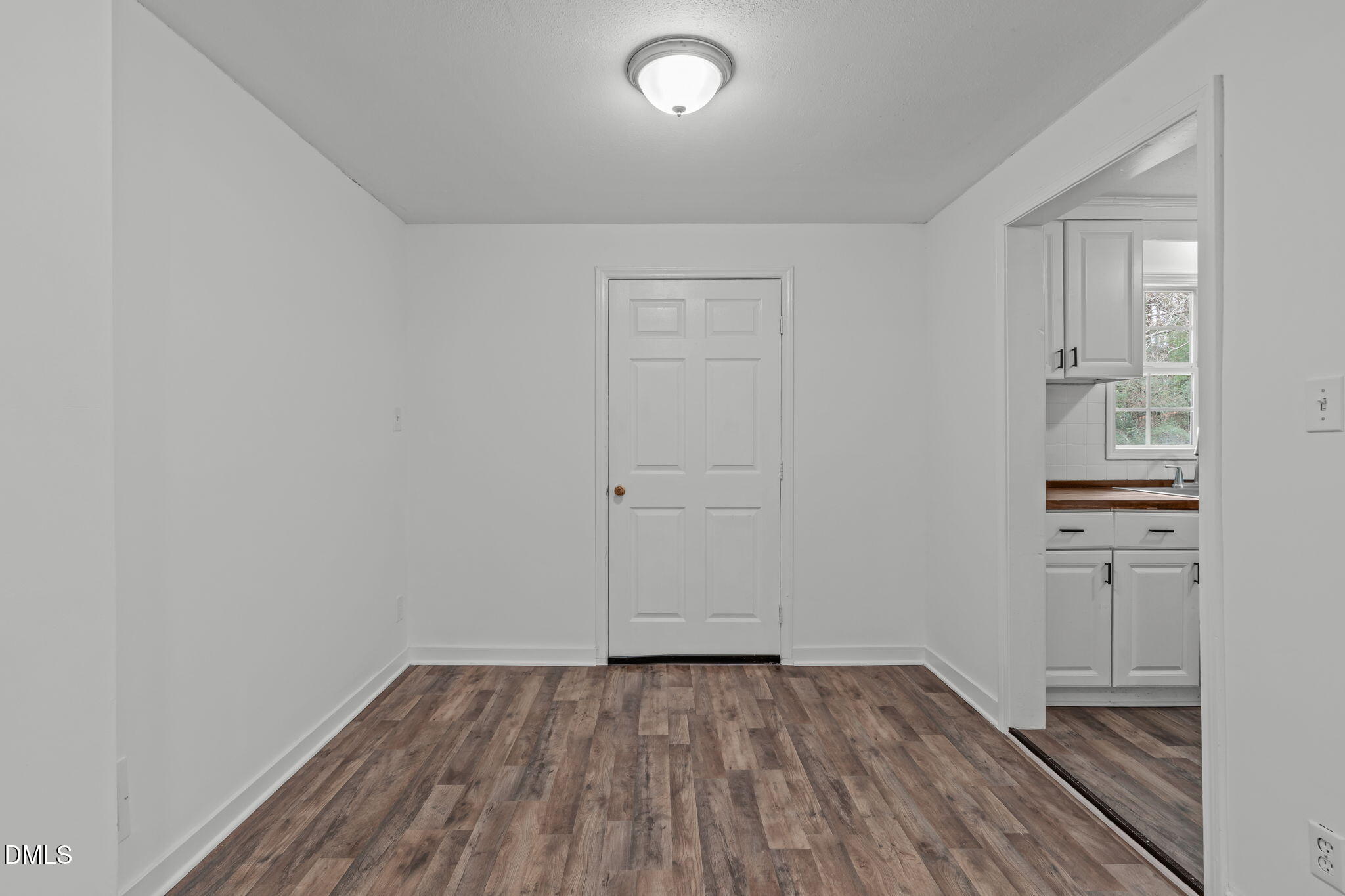 311 New Rand Road Garner, NC 27529 - Photo 9 of 31 wooden floor in an empty room with a window