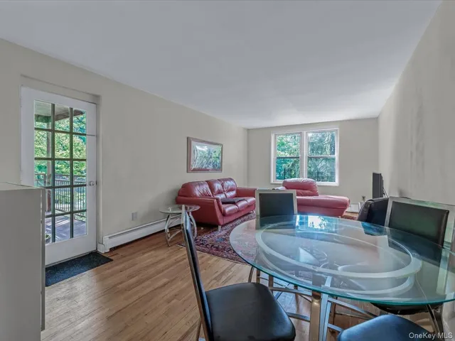 a view of a dining room with furniture window and wooden floor
