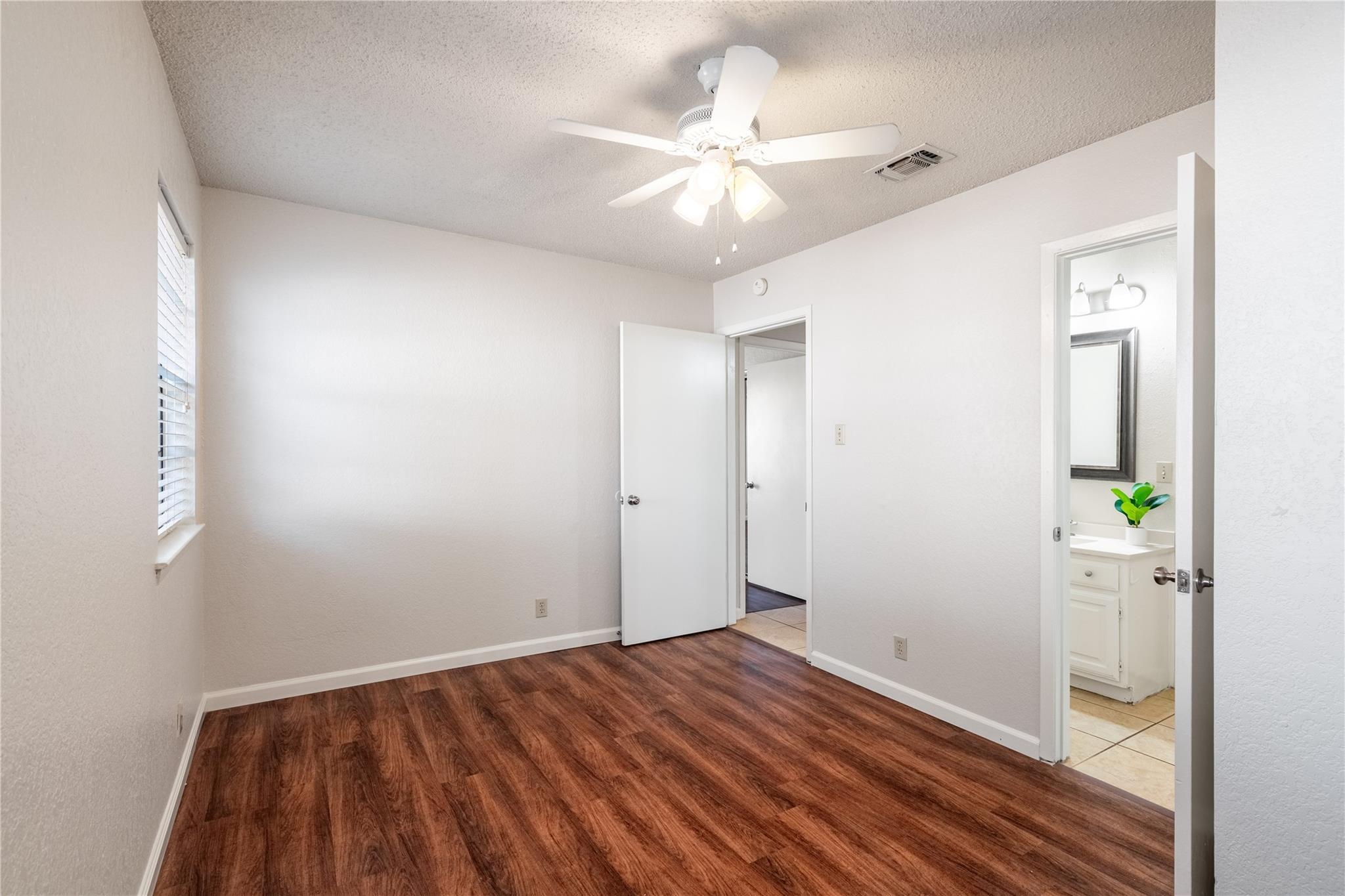 3800 Foust Trail, Unit B Georgetown, TX 78628 - Photo 11 of 16 A quiet retreat with durable flooring and a ceiling fan for comfort, featuring a connecting bath.