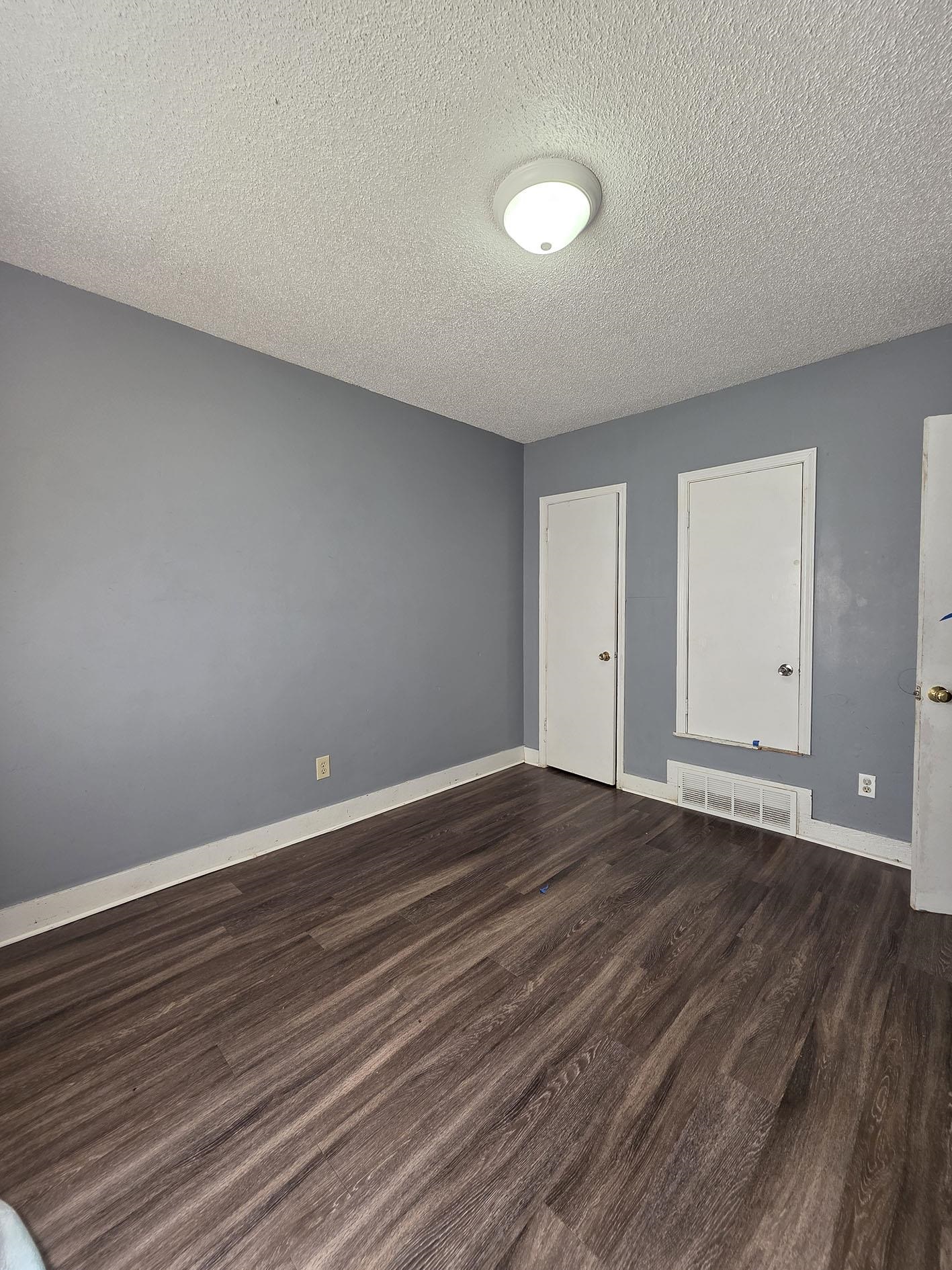 6521 Wimble Road Memphis, TN 38134 - Photo 13 of 18 Unfurnished room with dark wood-type flooring and a textured ceiling