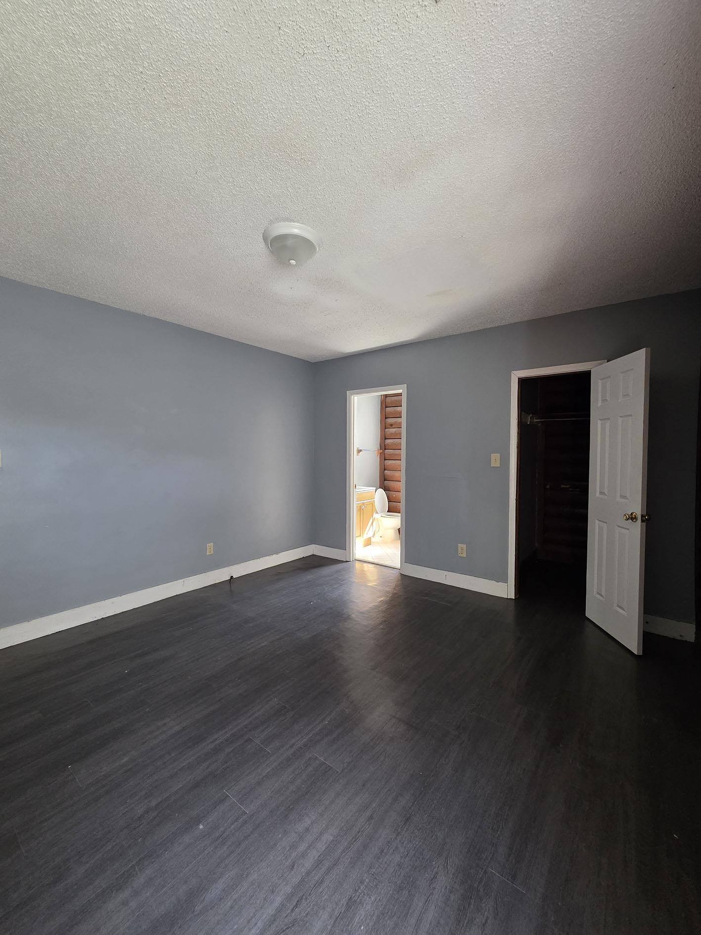 6521 Wimble Road Memphis, TN 38134 - Photo 18 of 18 Empty room featuring a textured ceiling and dark wood-type flooring