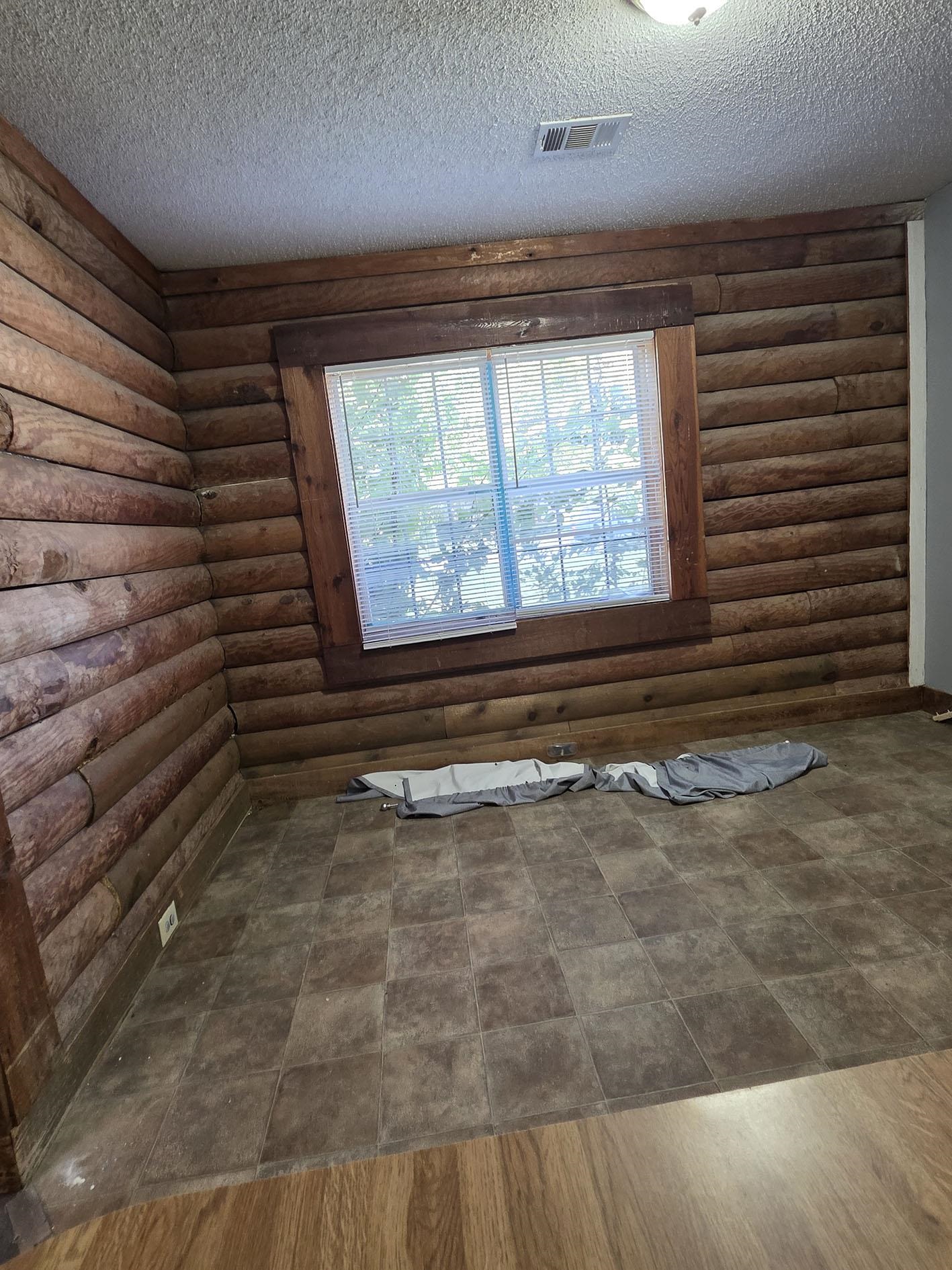 6521 Wimble Road Memphis, TN 38134 - Photo 4 of 18 Empty room with log walls and a textured ceiling