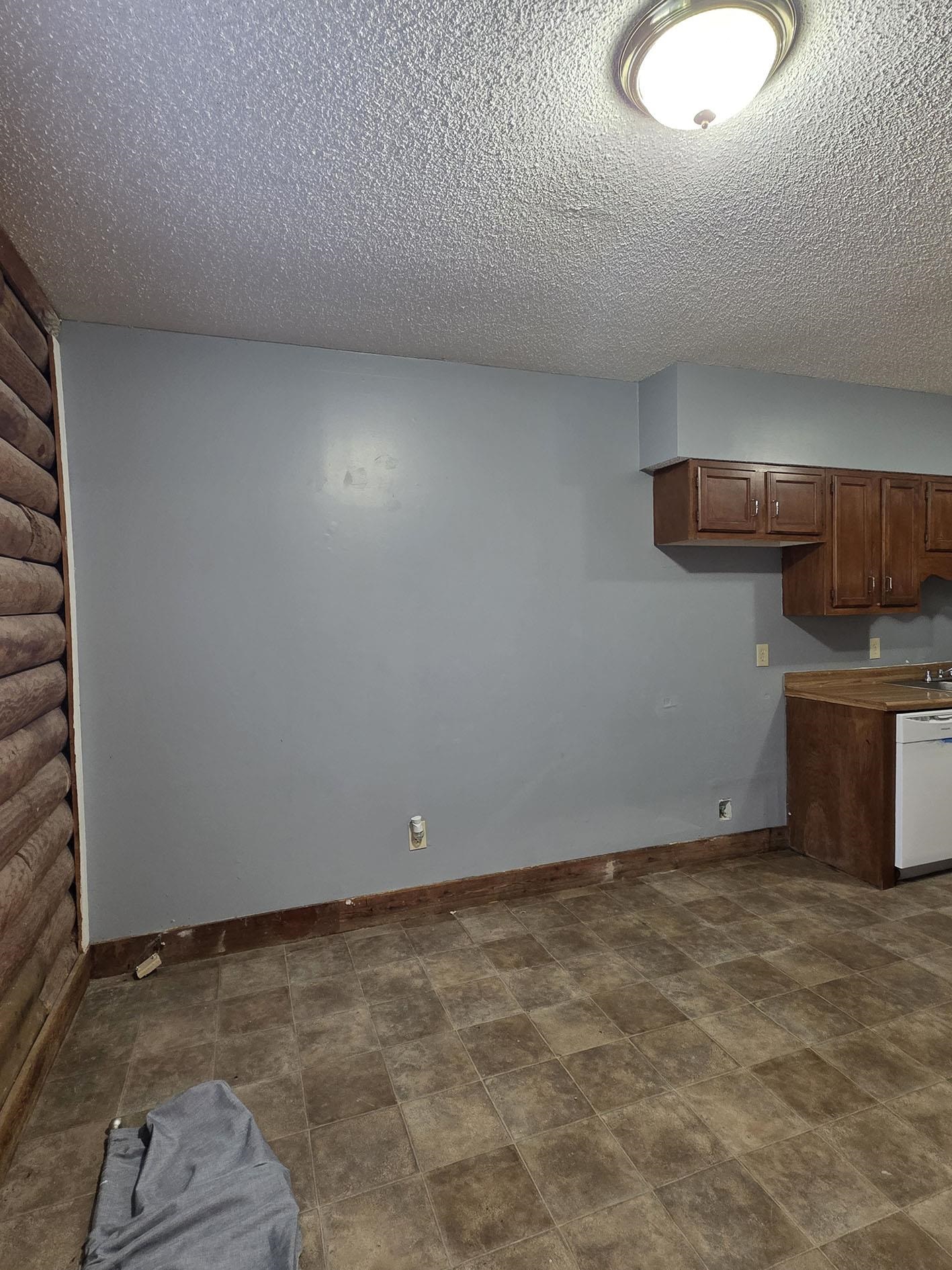 6521 Wimble Road Memphis, TN 38134 - Photo 5 of 18 Unfurnished dining area with baseboards and a textured ceiling