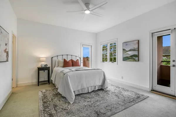 a bedroom with a bed and painting on the wall