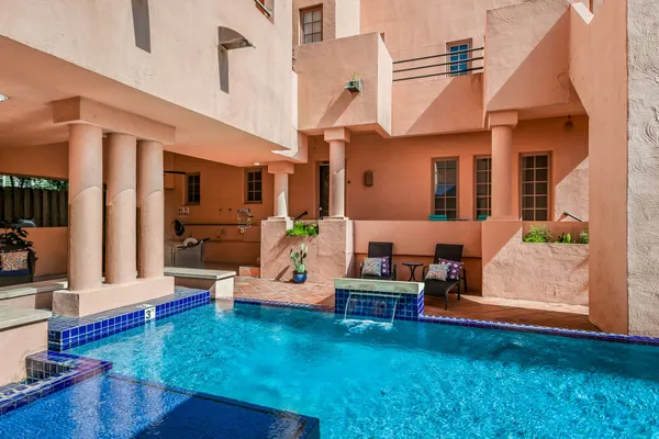 a view of a patio with couches chairs and potted plants with wooden floor