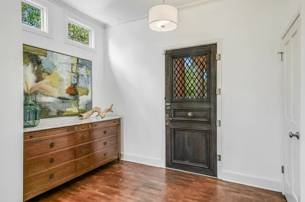 a room with cabinet and mirror