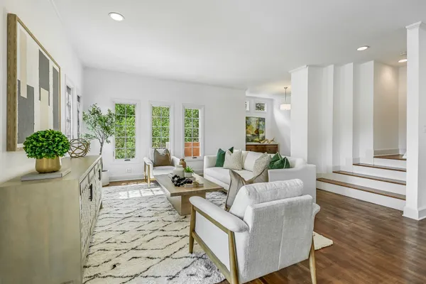 a living room with furniture and a floor to ceiling window
