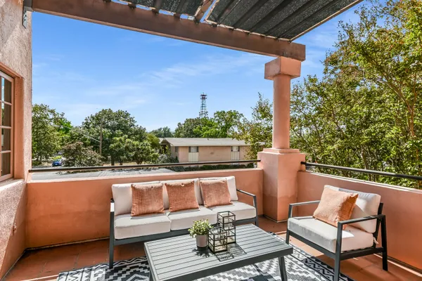 a view of a chair and tables in the balcony