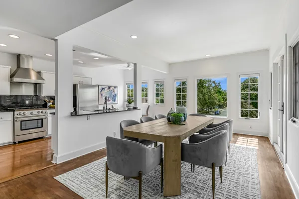 a kitchen with granite countertop kitchen island stainless steel appliances a table and chairs in it