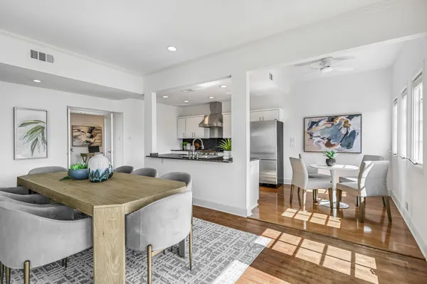 a kitchen with granite countertop kitchen island stainless steel appliances a table and chairs