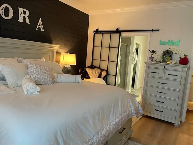 a bedroom with a bed and a television