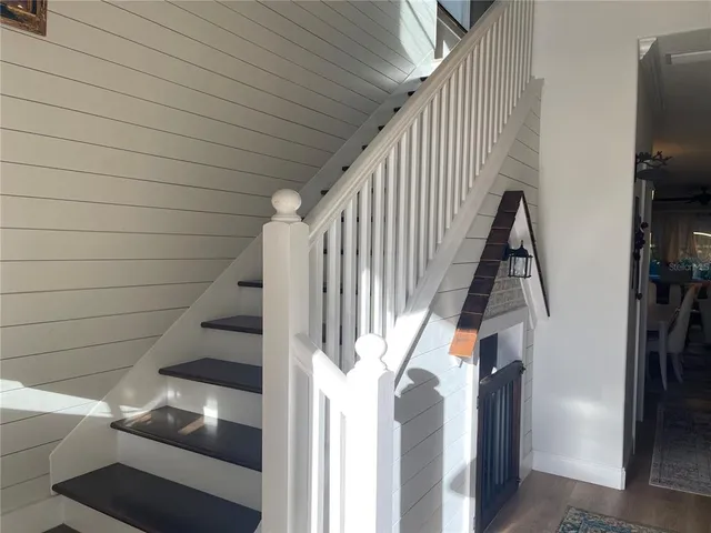 a bedroom with a bed and a mirror on dresser