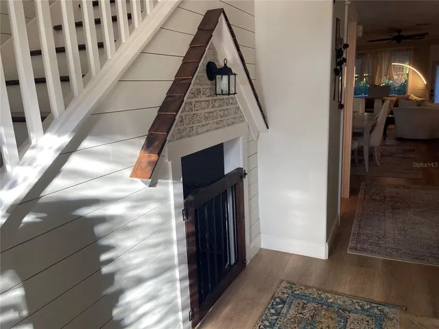 a view of a dining room with furniture large window chandelier and wooden floor