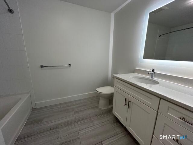 111 Morgan Street, Unit TH5 Stamford, CT 06905 - Photo 16 of 23 a bathroom with a granite countertop sink a toilet and a mirror