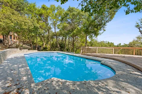 a view of a swimming pool with a yard