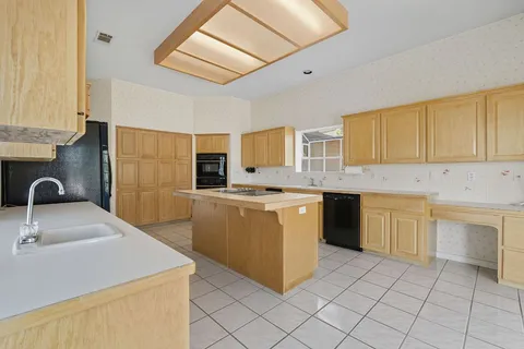 a kitchen with stainless steel appliances granite countertop a sink and a stove