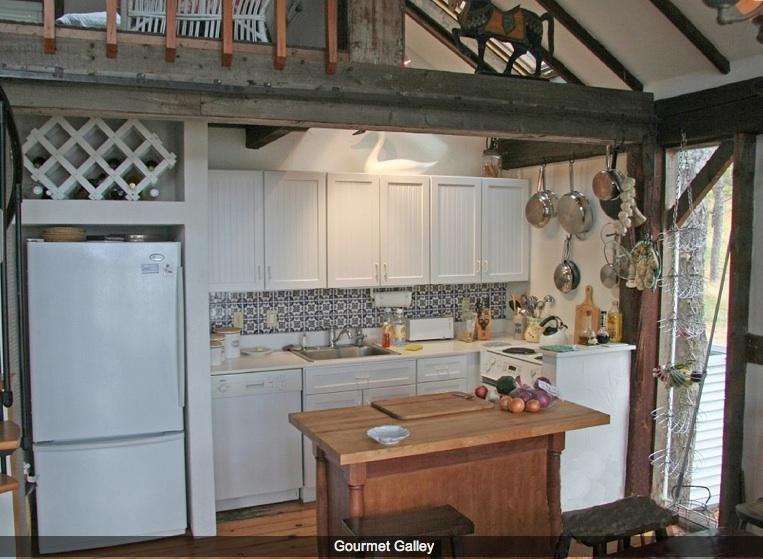 165 Baker Road Wellfleet, MA 02667 - Photo 10 of 20 a room with a table chairs and a refrigerator