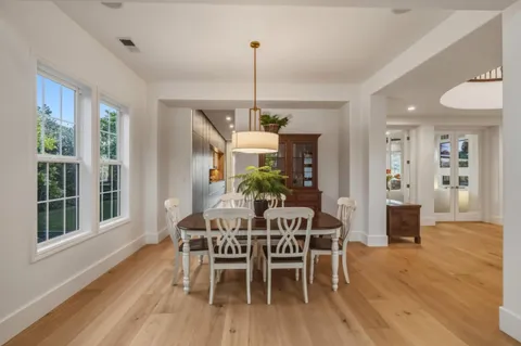 a kitchen with stainless steel appliances granite countertop a sink a stove and a wooden floors