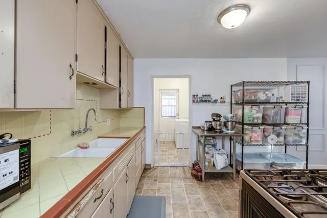 a kitchen with a sink and a stove top oven