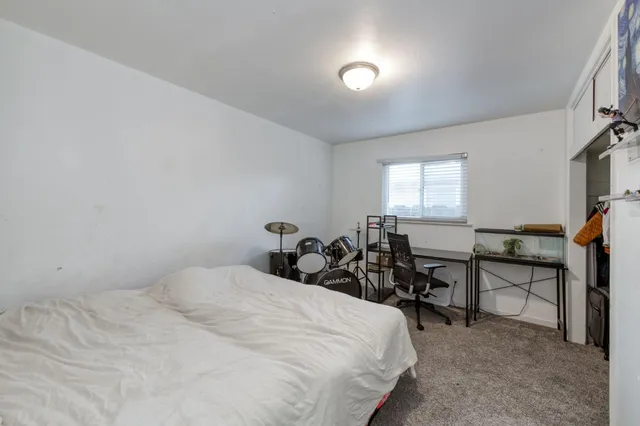 a bedroom with bed and a window