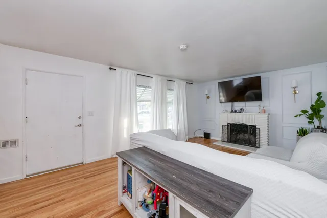 a bed room with a fireplace and a television