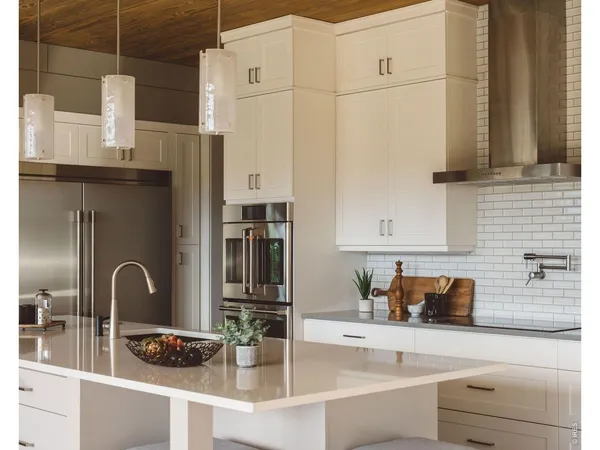 a kitchen with stainless steel appliances granite countertop a sink and cabinets