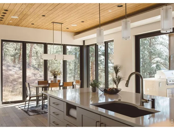 a kitchen with large windows and a table