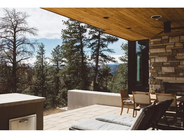 a view of a patio with a table and chairs