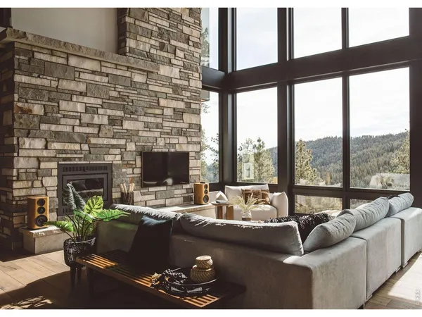 a living room with furniture fireplace and a floor to ceiling window
