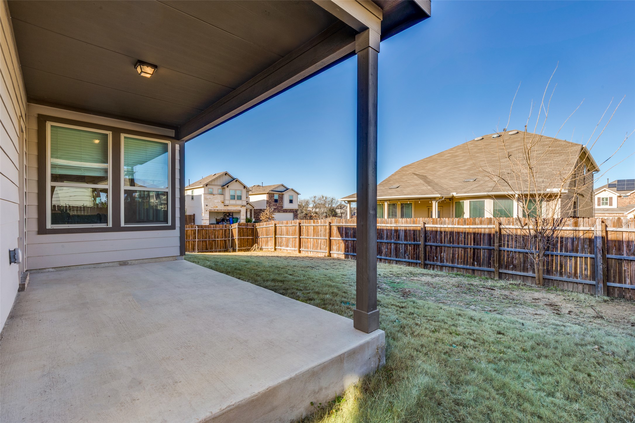 3208 Maysillee Street Austin, TX 78728 - Photo 18 of 23 Fenced backyard with a covered patio area and a residential view