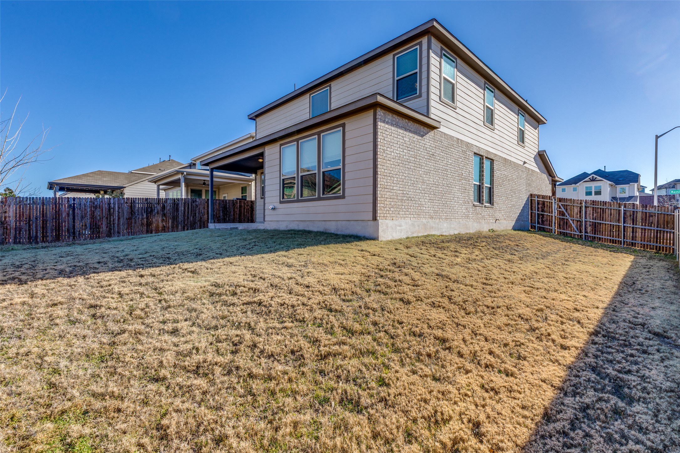3208 Maysillee Street Austin, TX 78728 - Photo 20 of 23 Rear view of house featuring a fenced backyard, brick siding, and a patio