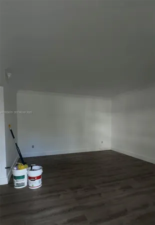 a view of room with wooden floor