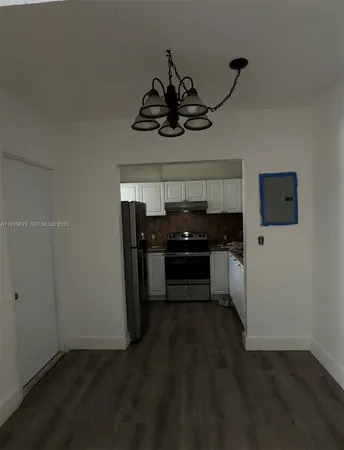 a kitchen with a stove and a refrigerator