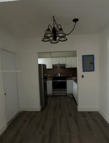 a kitchen with a stove and a refrigerator