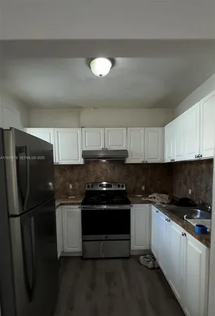 a kitchen with a sink and stainless steel appliances