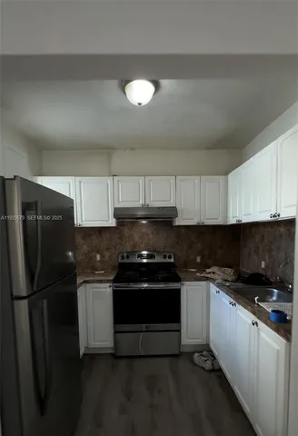 a kitchen with a sink and stainless steel appliances