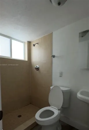 a white toilet sitting next to a bathroom sink